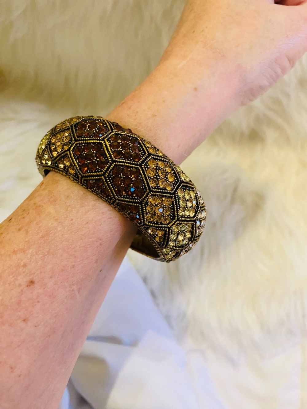 Cuff bracelet with a honeycomb pattern and amber-colored rhinestones